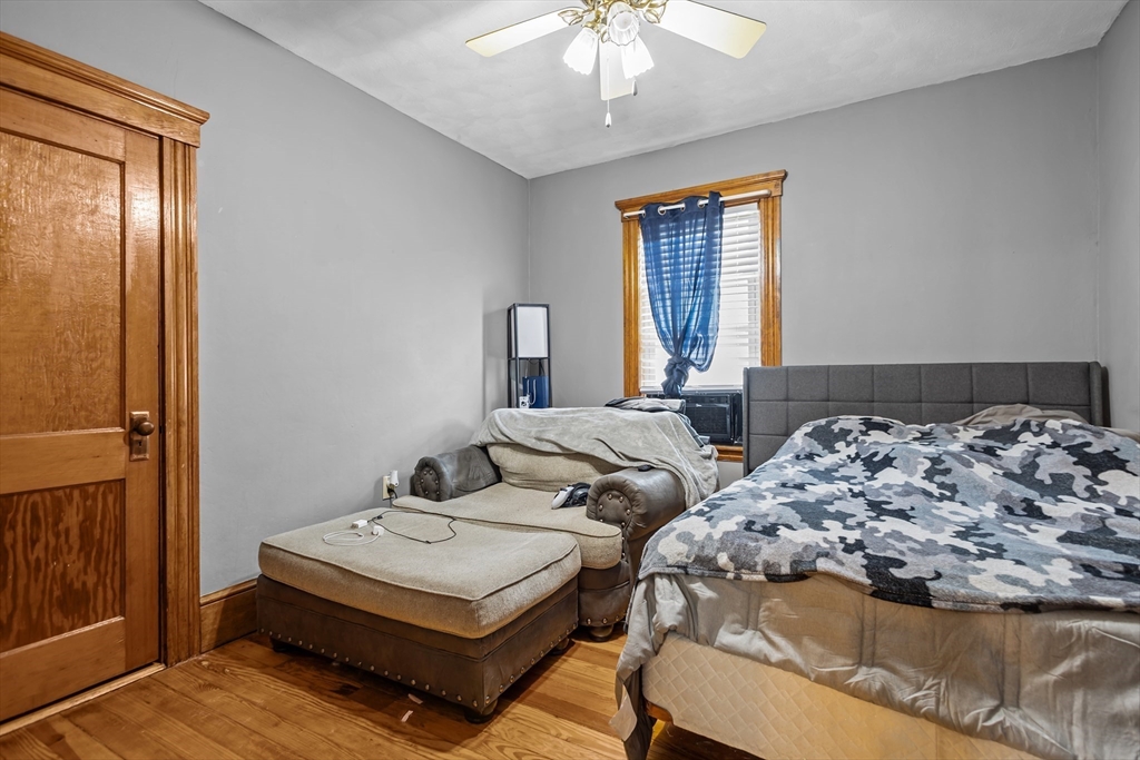97 Warwick Street Woonsocket, RI 02895 - Photo 34 of 40 a bedroom with two beds and a chandelier