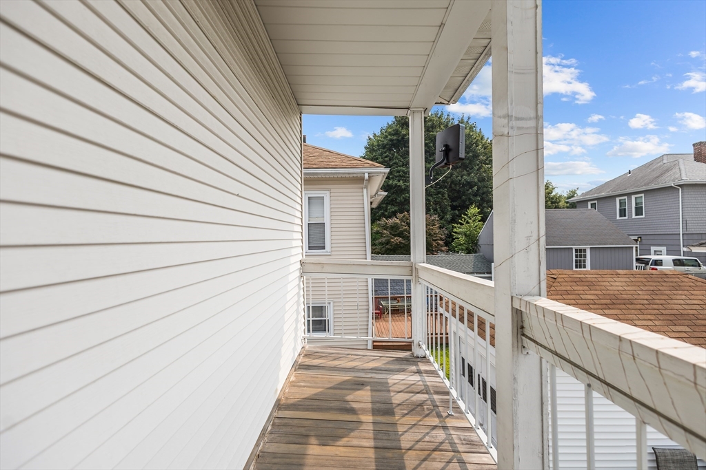 97 Warwick Street Woonsocket, RI 02895 - Photo 36 of 40 a view of a balcony with floor to ceiling window with wooden floor