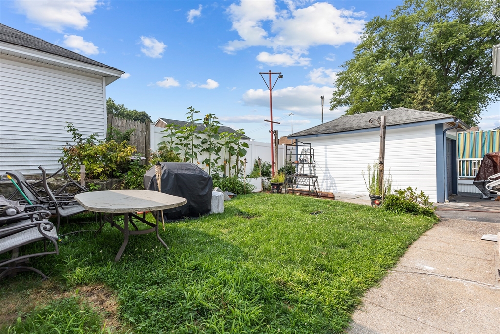 97 Warwick Street Woonsocket, RI 02895 - Photo 5 of 40 a view of a chair and table in backyard of the house