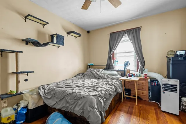 a bedroom with a bed and a window