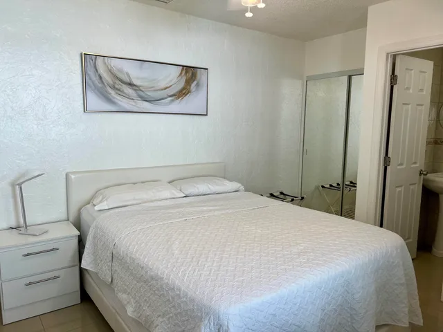 a bedroom with a bed and a painting on the wall