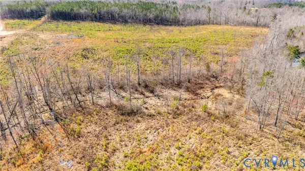 a view of a yard with wooden fence