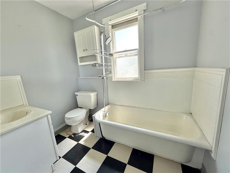 805 Stambaugh Avenue Sharon, PA 16146 - Photo 14 of 17 a bathroom with a toilet and a bathtub