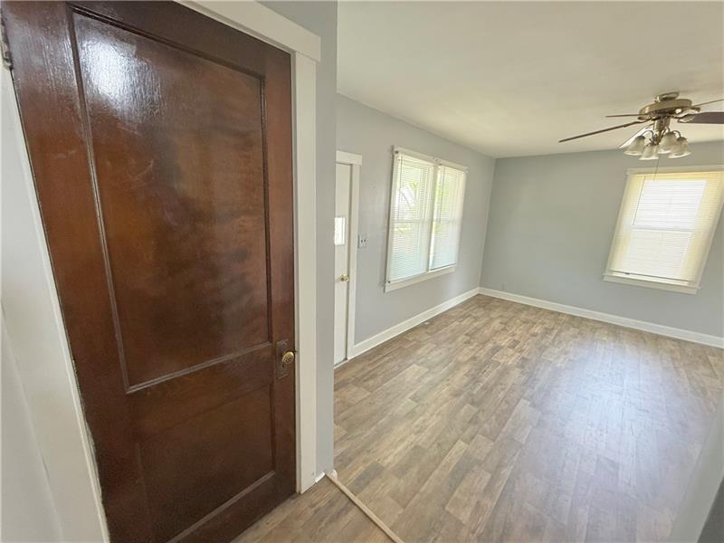 805 Stambaugh Avenue Sharon, PA 16146 - Photo 15 of 17 an empty room with wooden floor and windows