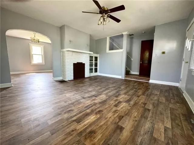 a view of a livingroom with a fireplace and window