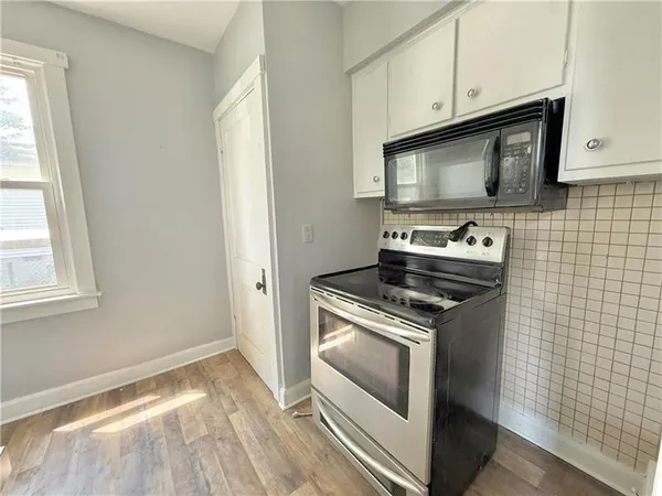 a kitchen with a stove and a microwave