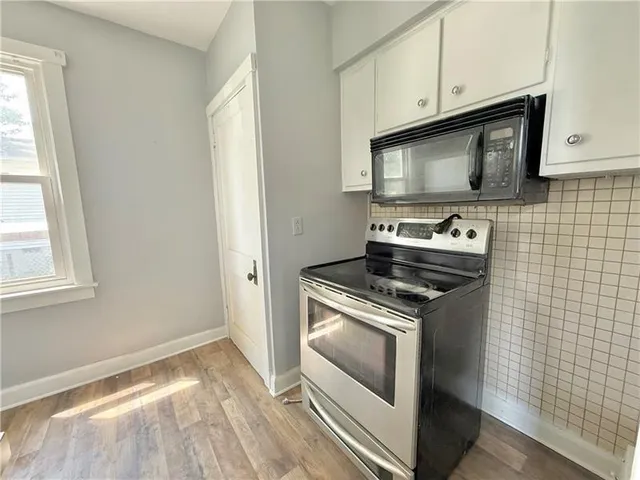 a kitchen with a stove and a microwave