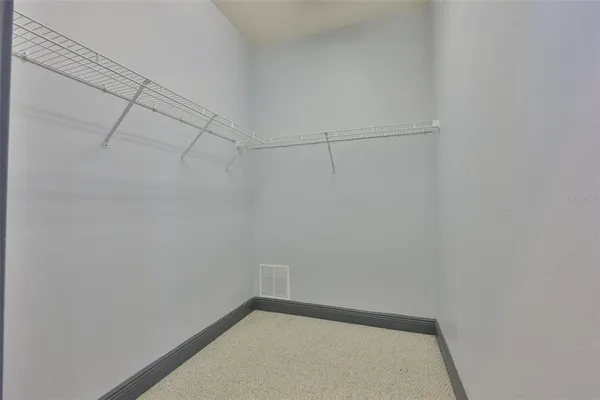 a spacious bedroom with a bed and a couch