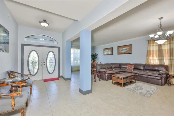 a dining room with furniture and a flat screen tv