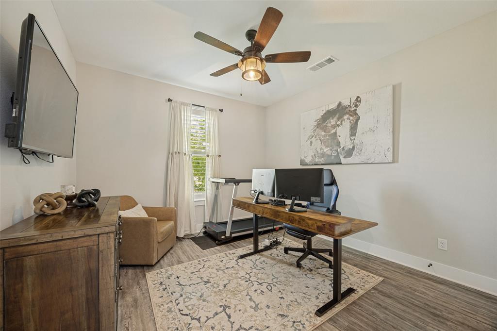 1105 Ranch Drive Bonham, TX 75418 - Photo 21 of 25 Versatile room featuring wood-finish flooring, a ceiling fan with light fixture, and a window with blinds. This bedroom is being used as a secondary office.