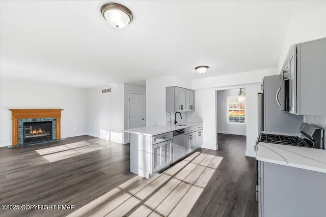 a large kitchen with cabinets and a wooden floor