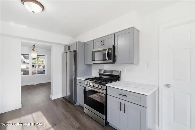 a kitchen with a refrigerator stove and microwave