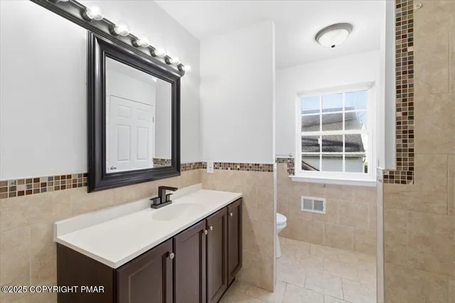an empty room with wooden floor and a window