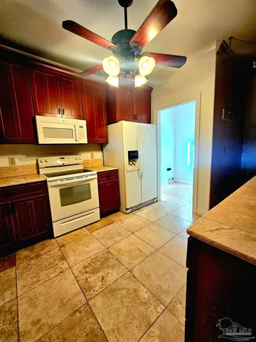 a kitchen with stainless steel appliances granite countertop a sink a counter space cabinets and a window