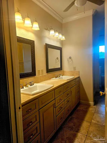 a bathroom with a granite countertop sink a toilet and shower