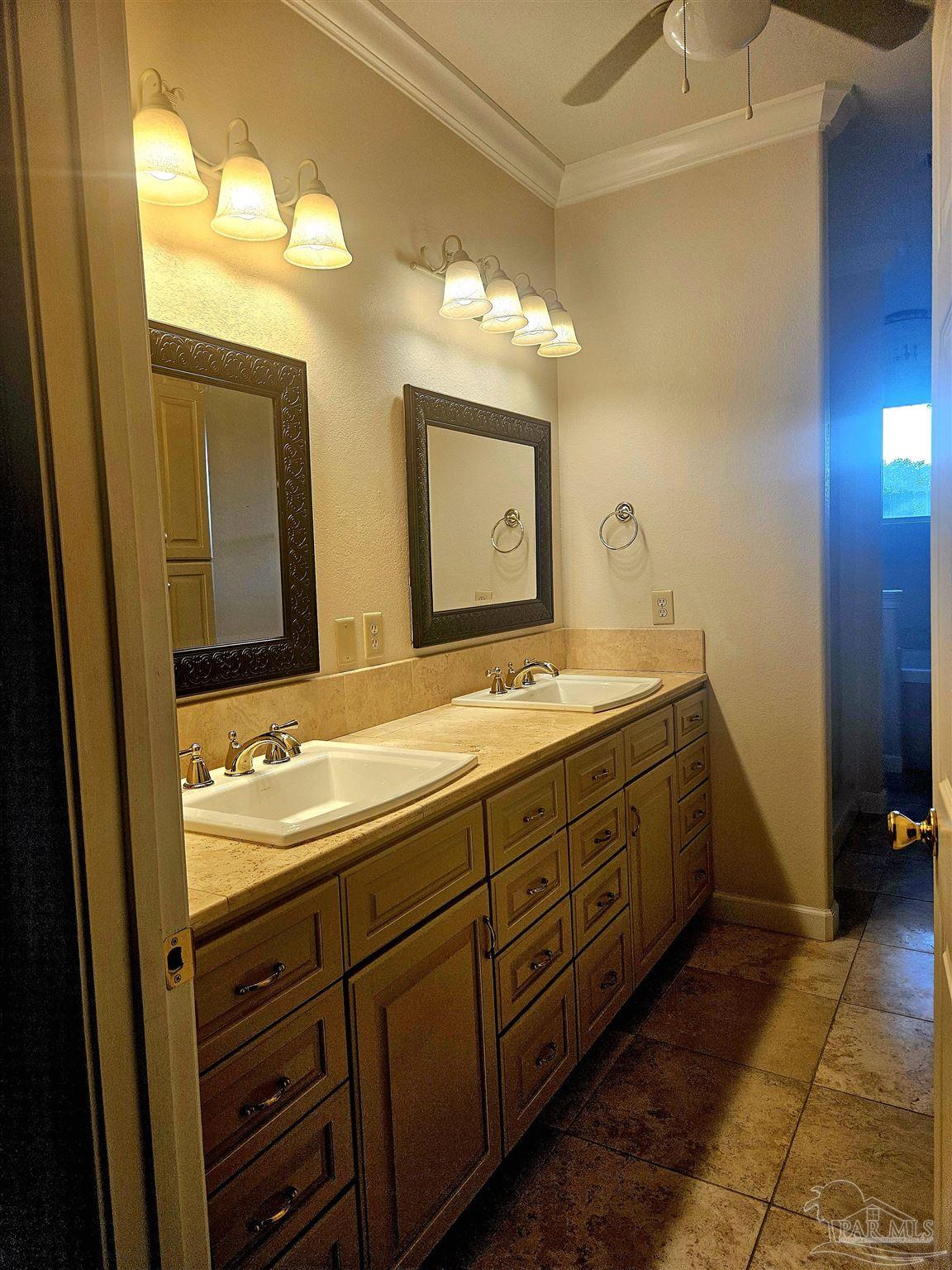 6148 The Oaks Lane, Unit B Pensacola, FL 32504 - Photo 7 of 20 a bathroom with a double vanity sink and a mirror