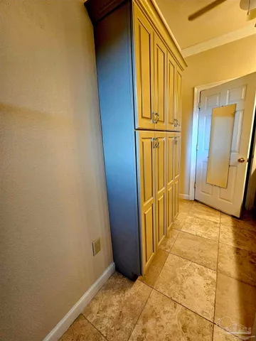 an empty room with wooden floor fireplace and windows