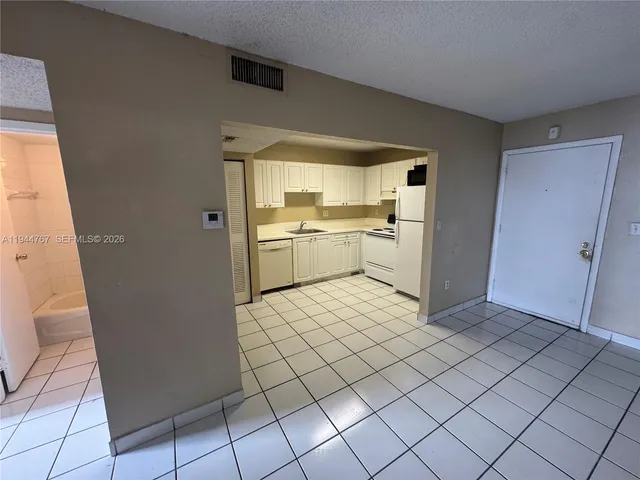 a room with a wooden floor and a sink