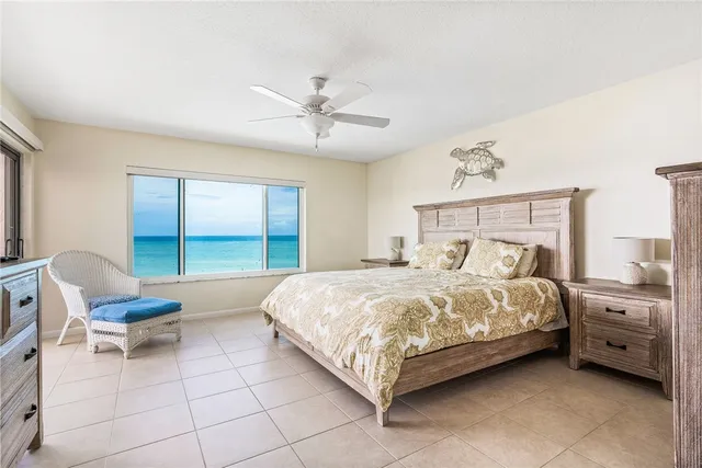 a bedroom with a large bed and a tv