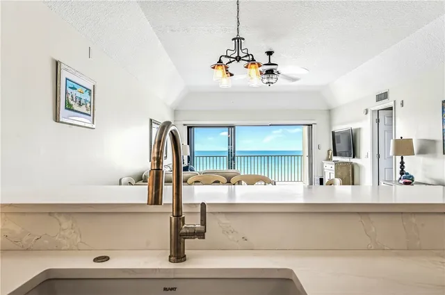 a kitchen with granite countertop a refrigerator and a stove