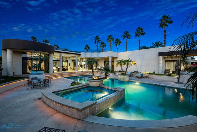 a view of a swimming pool with outdoor seating