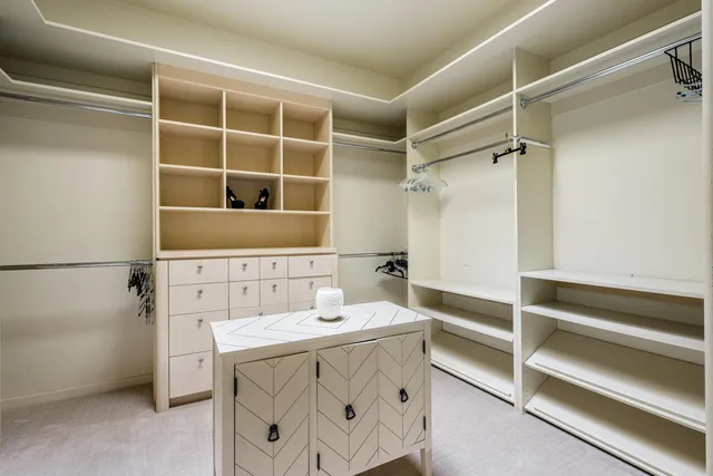 a bathroom with double vanity sinks a vanity a lamp and a mirror