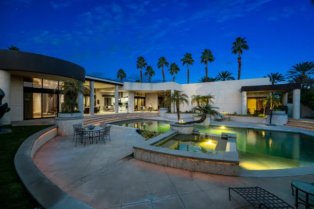 a view of a house with backyard sitting area and garden