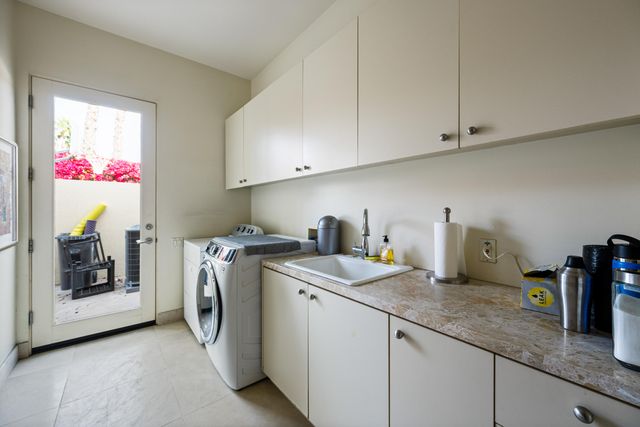 a view of a house with swimming pool and sitting area