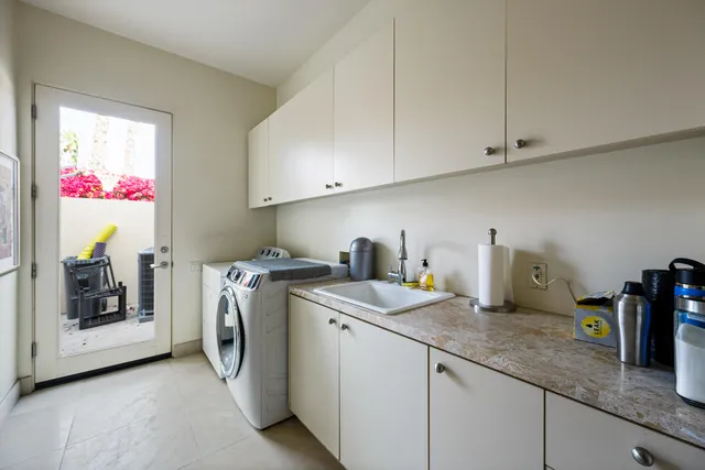 a view of a house with swimming pool and sitting area