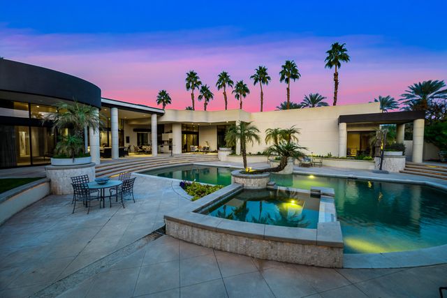 a view of a house with swimming pool and a yard