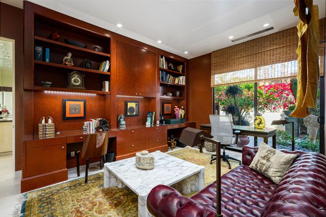 a living room with furniture and large window