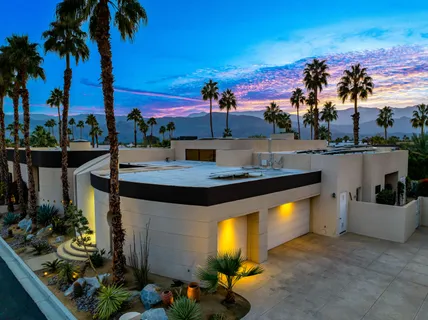 a view of a house with backyard porch and sitting area