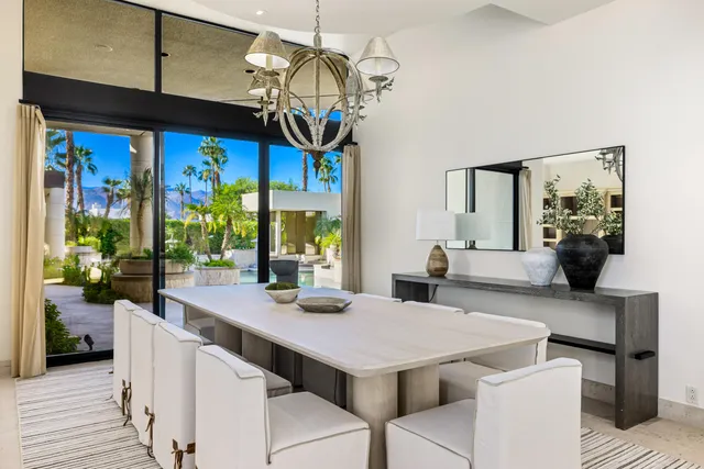 an aerial view of a swimming pool with outdoor seating