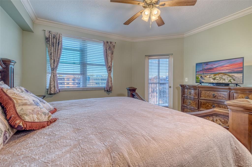 960 Starkey Road, Unit 1502 Largo, FL 33771 - Photo 12 of 36 a bedroom with a bed and a chandelier