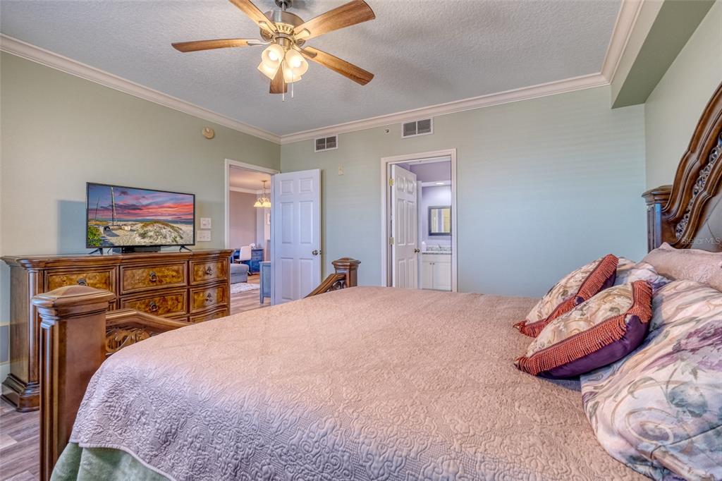 960 Starkey Road, Unit 1502 Largo, FL 33771 - Photo 15 of 36 a bedroom with a bed and a flat screen tv