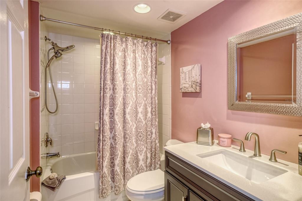 960 Starkey Road, Unit 1502 Largo, FL 33771 - Photo 19 of 36 a bathroom with a sink toilet tub and shower