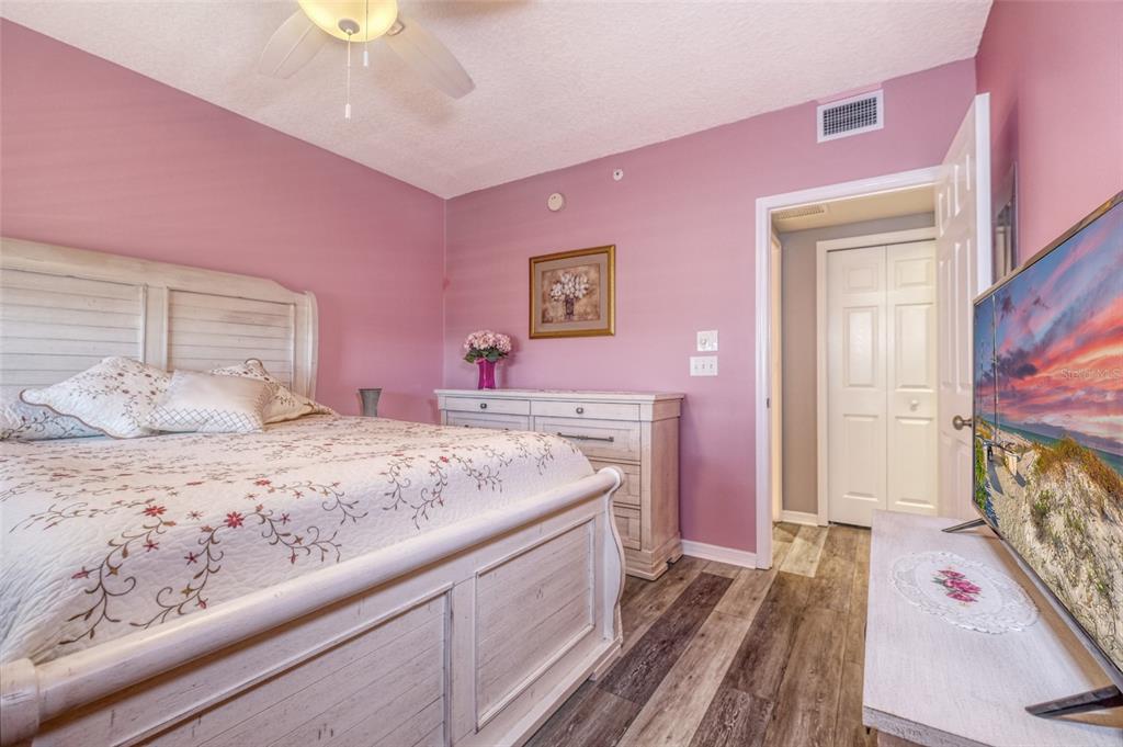 960 Starkey Road, Unit 1502 Largo, FL 33771 - Photo 20 of 36 a spacious bathroom with a sink a mirror and a bedroom