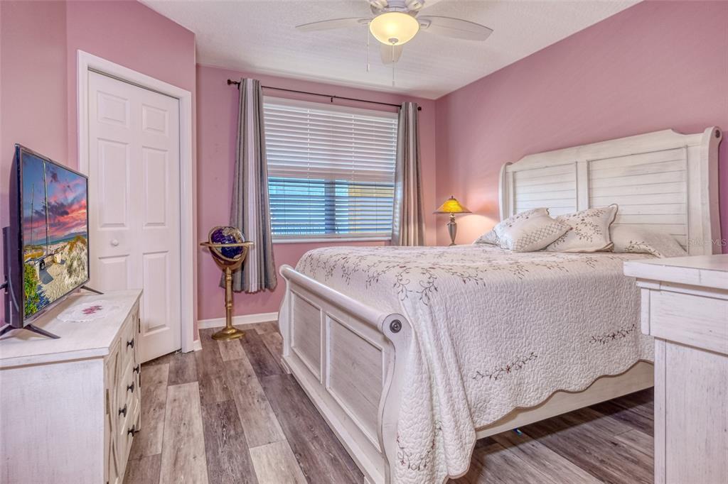 960 Starkey Road, Unit 1502 Largo, FL 33771 - Photo 21 of 36 a bedroom with a bed and a flat tv screen on dresser