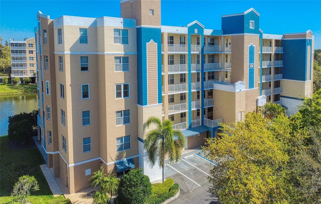 960 Starkey Road, Unit 1502 Largo, FL 33771 - Photo 30 of 36 a front view of a multi story residential apartment building with a yard