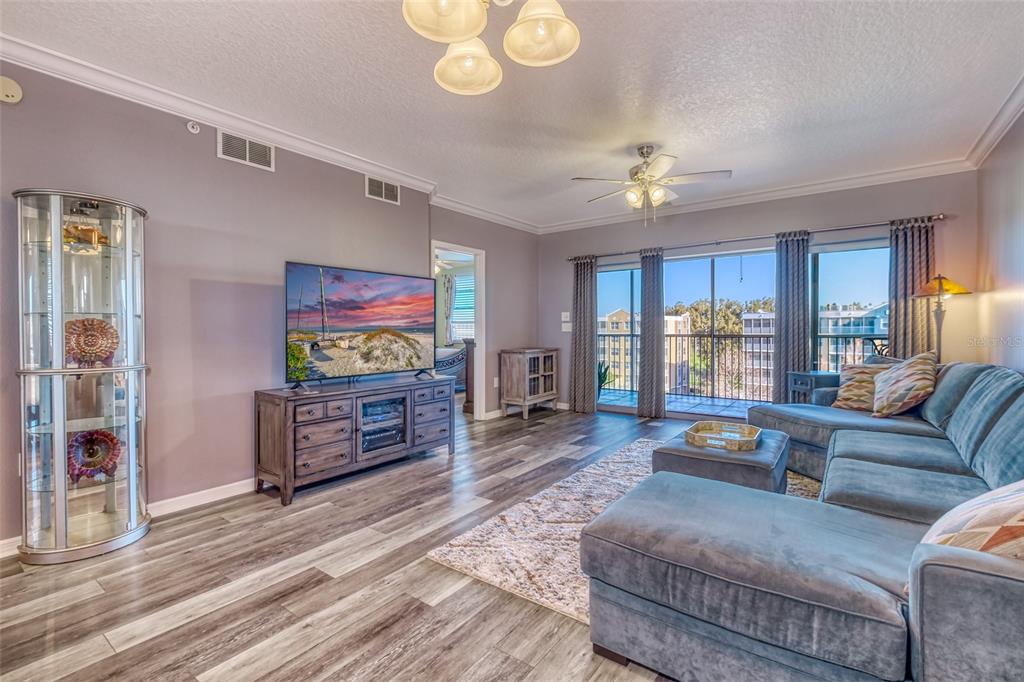 960 Starkey Road, Unit 1502 Largo, FL 33771 - Photo 3 of 36 a living room with furniture and a flat screen tv