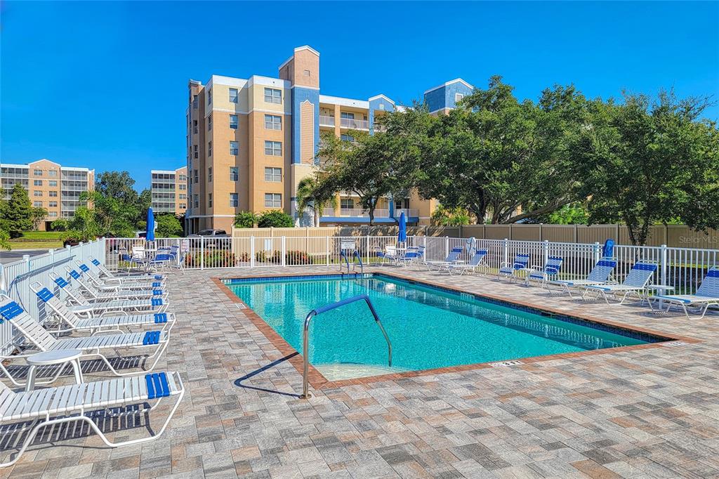 960 Starkey Road, Unit 1502 Largo, FL 33771 - Photo 34 of 36 a view of a swimming pool with a lounge chairs