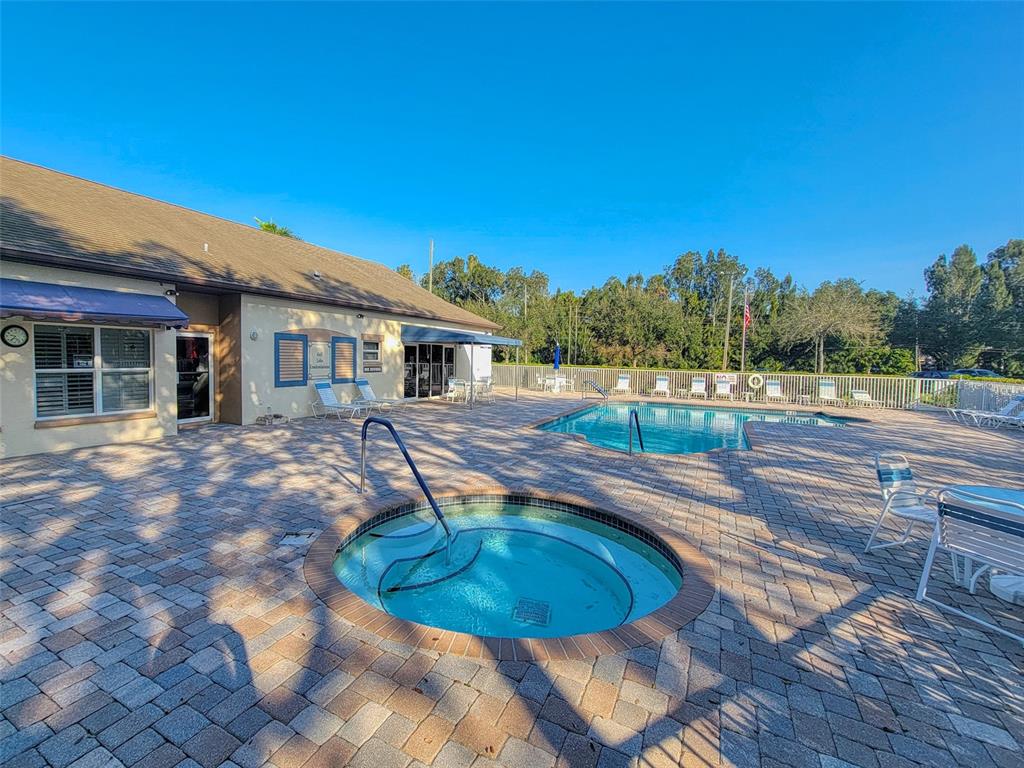 960 Starkey Road, Unit 1502 Largo, FL 33771 - Photo 36 of 36 a view of a swimming pool with an outdoor space and seating area