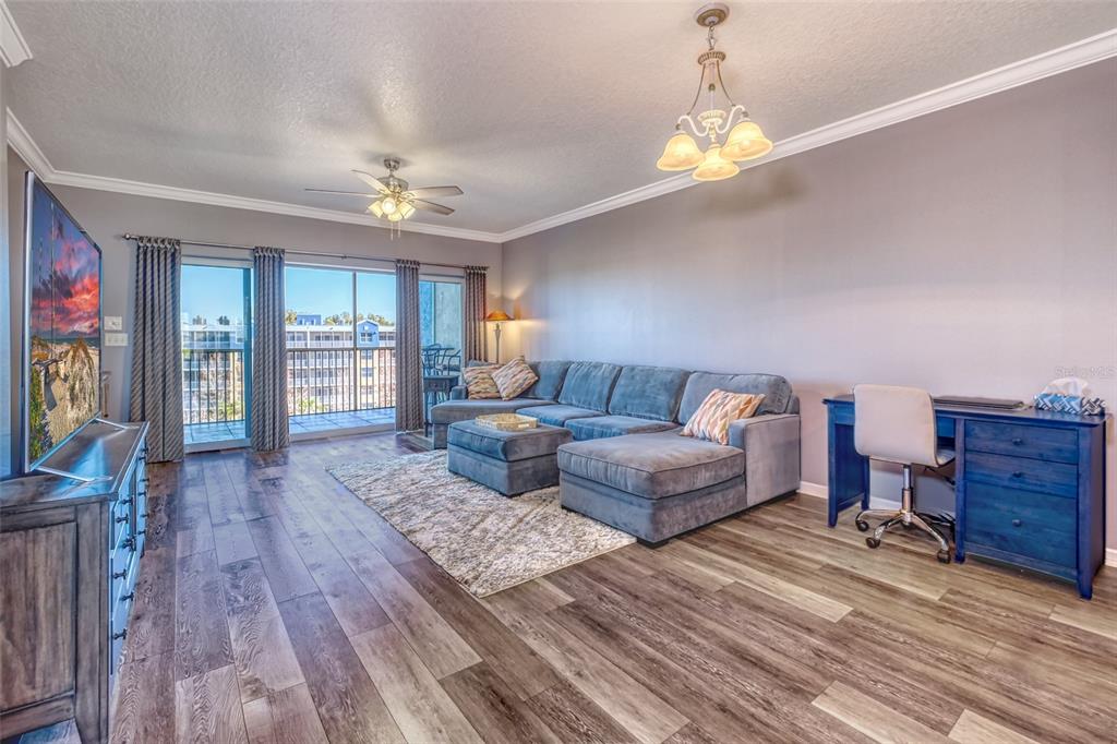 960 Starkey Road, Unit 1502 Largo, FL 33771 - Photo 4 of 36 a living room with furniture and a chandelier