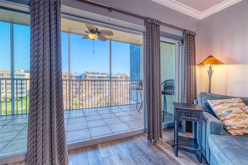 960 Starkey Road, Unit 1502 Largo, FL 33771 - Photo 5 of 36 a view of a bedroom with wooden floor and furniture
