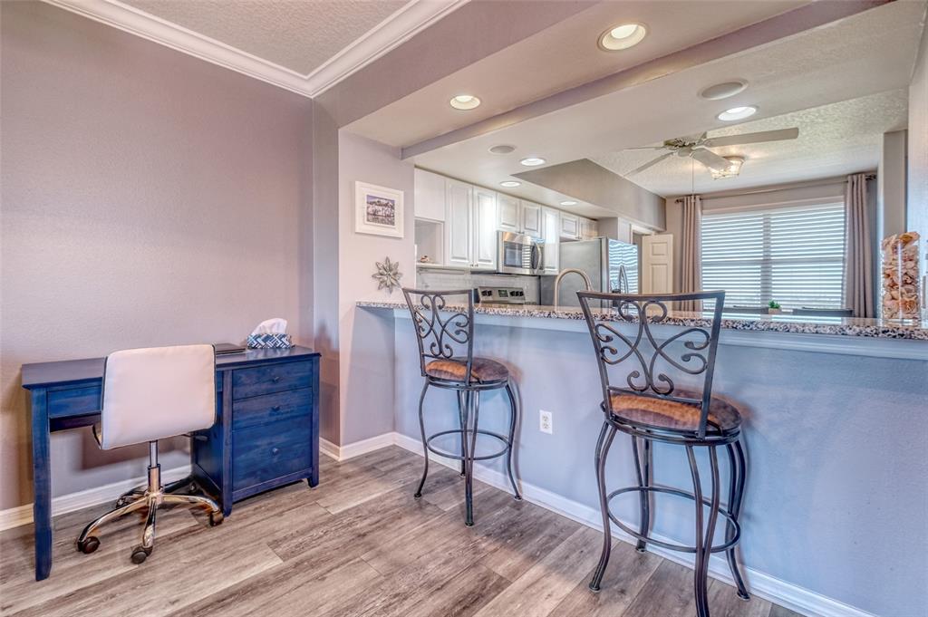 960 Starkey Road, Unit 1502 Largo, FL 33771 - Photo 7 of 36 a view of a work space with furniture and wooden floor