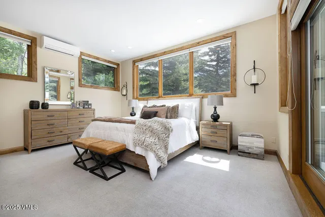 a bedroom with furniture and a large window