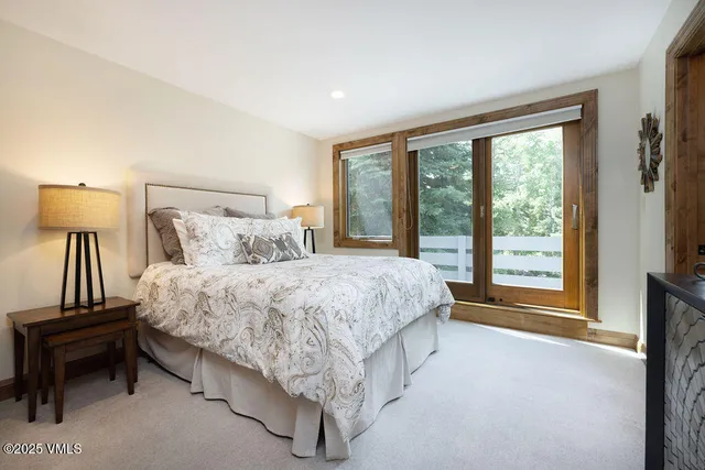 a spacious bedroom with a bed and a night stand