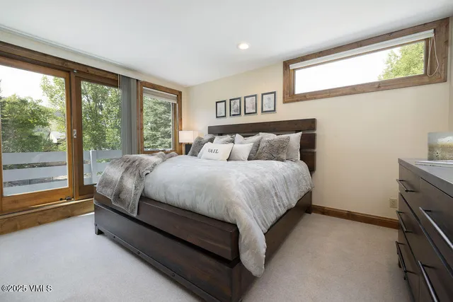 a bed sitting in a bedroom next to a window