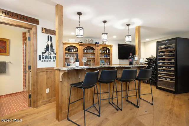 a view of a kitchen with stainless steel appliances kitchen island granite countertop a refrigerator and a stove top oven