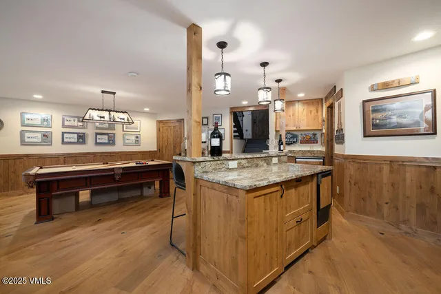 a kitchen with granite countertop a stove and a wooden floors